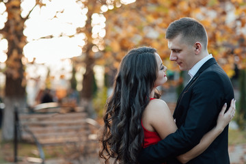 Young couple posing in the autumn park