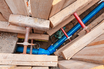 Repair work on the replacement of polypropylene water pipes in the city using wooden spacers for soil