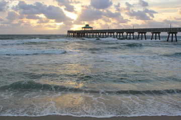 Sunrise by the pier at Deerfield Beach, Florida.