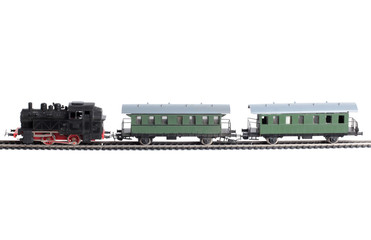 Obraz premium Model of a steam locomotive and passenger cars on rails on a white background