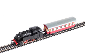 Model of a steam locomotive and passenger cars on rails on a white background