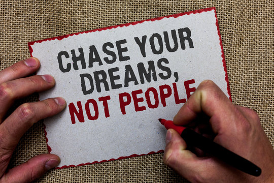 Word writing text Chase Your Dreams, Not People. Business concept for Do not follow others chasing goals objectives On jute ground human hand written some texts on red bordered paper