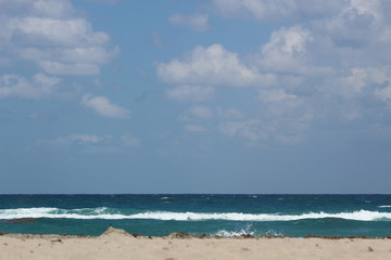 Fototapeta na wymiar Waves on a cloudy day at Pompano Beach, Florida.