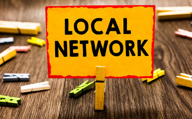 Conceptual hand writing showing Local Network. Business photo showcasing Intranet LAN Radio Waves DSL Boradband Switch Connection Clothespin holding orange paper note clothespin wooden floor
