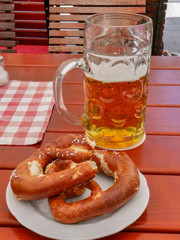 German Oktoberfest style stein glass of beer and salted pretzel, Munich, Germany, August 2nd 2019