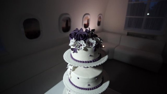 beautiful three-tier wedding cake stands on the table