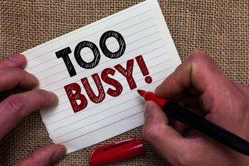 Writing note showing Too Busy. Business photo showcasing No time to relax no idle time for have so much work or things to do Man's hand hold white paper with symbolic letter jute sack background