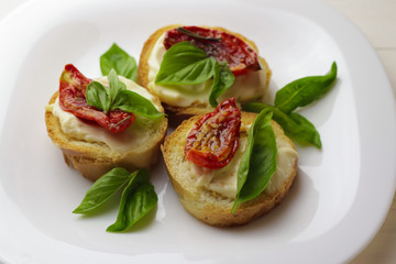 Tasty  with sun-dried tomatoes on wooden table