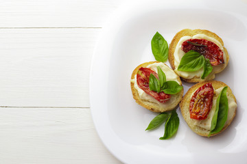Tasty  with sun-dried tomatoes on wooden table