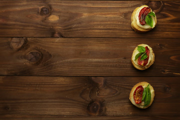 Fototapeta premium Tasty with sun-dried tomatoes on wooden table