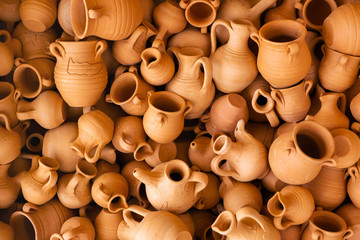 clay souvenir pots lie together. handmade for sale. the view from the top
