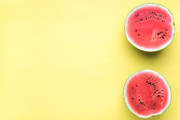 Obraz na płótnie Canvas Colorful fruit minimal background of fresh watermelon slices on yellow background