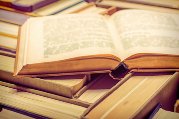 An old open book in a hard cloth cover, close-up.