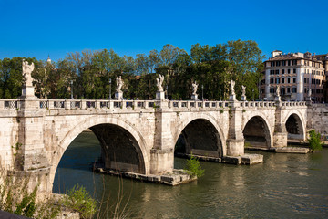 Fototapeta premium ROME, ITALY - APRIL, 2018: Sant Angelo Bridge over the Tiber River completed in 134 AD by the Emperor Hadrian