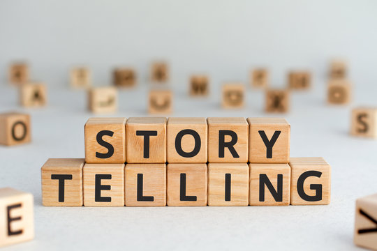story telling - words from wooden blocks with letters, the art of telling stories storytelling concept, random letters around, white  background