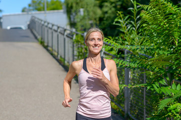 Determined woman smiling happy while jogging