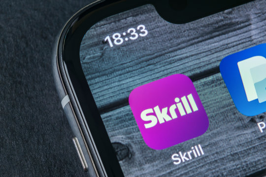 Sankt-Petersburg, Russia, April 12, 2018: Skrill application icon on Apple iPhone X smartphone screen close-up. Skrill app icon. Skrill is an online electronic finance payment system.