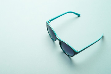 Stylish plastic dark sunglasses on colorful background. Eye care and diseases concept, eye...