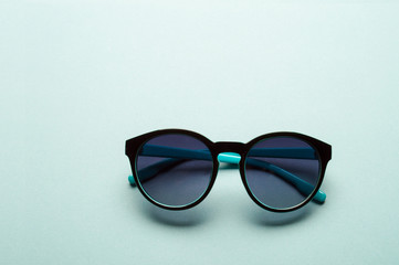 Stylish plastic dark sunglasses on colorful background. Eye care and diseases concept, eye...
