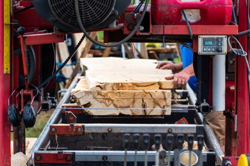 A mobile sawmill is setup at a local farm and livestock show in Ruckersville, VA. Boards are cut on site and sold to customers as they are needed.