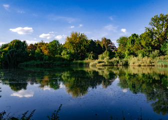 Fototapeta na wymiar beautiful autumn landscape, bright trees on the shore of a pond
