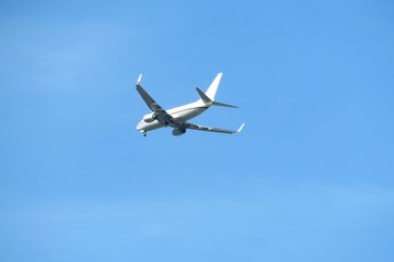 Fototapeta na wymiar Airplane on blue sky background