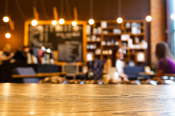 Wooden top table with blurred of coffee shop background. Mockup wooden desk for display or montage your products. Blur in coffee shop or cafe, restaurant background.