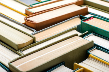 Old and used hardcover books. Educational concept. Closeup