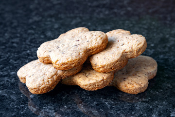 Nuts cookies. Nut biscuits lying on a dark marble table.