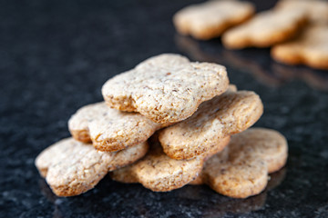 Fototapeta na wymiar Nuts stack cookies. Nut biscuits lying on a dark marble table.
