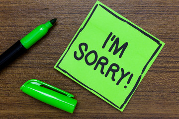 Conceptual hand writing showing I am Sorry. Business photo showcasing To ask for forgiveness to someone you unintensionaly hurt Green Paper Communicate ideas Marker Wooden background