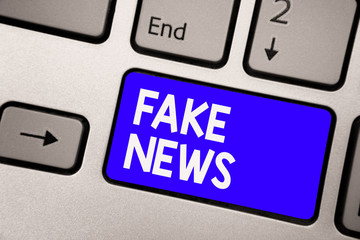 Handwriting text Fake News. Concept meaning Giving information to people that is not true by the...