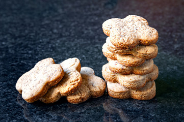 Fototapeta na wymiar Nuts cookie group. A close-up of a stack of walnut cookies lies on a dark marble table.