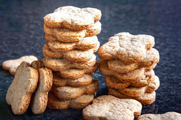 Nuts cookies a lot. Close-up of a stack of peanut cookies lay on a dark marble table.