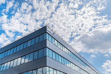 Modern office buildings in the background of the sky with clouds.