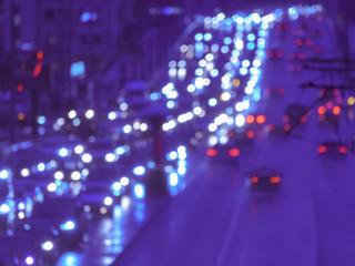 Fototapeta na wymiar Defocused image of hard night for drivers. Big traffic in the city. In the summer urban highway filled cars. To be late. Long exposure. For greeting card design, postcard template, guide, poster.