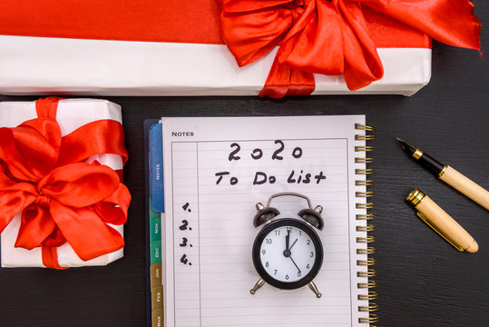 New year, clock, notepad and gift on table