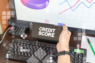 Credit Score concept. Business analyst conducts an analysis at a computer with graphs and holds in...