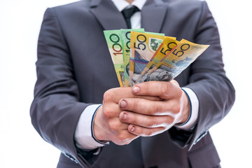 Man in suit offer australian dollar banknotes