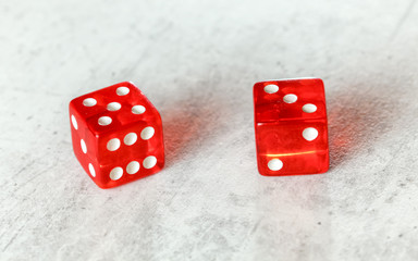 Two translucent red craps dices on white board showing Easy Eight number 5 and 3