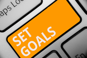 Writing note showing Set Goals. Business photo showcasing Defining or achieving something in the future based on plan Keyboard orange key Intention computer computing reflection document