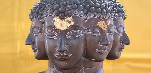 buddha heads with gold on the front and gold on the background in a temple in bangkok thailand