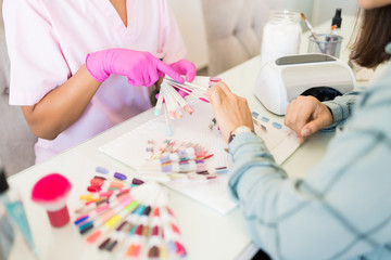 Obraz na płótnie Canvas Choice Of Nail Color In Beauty Salon