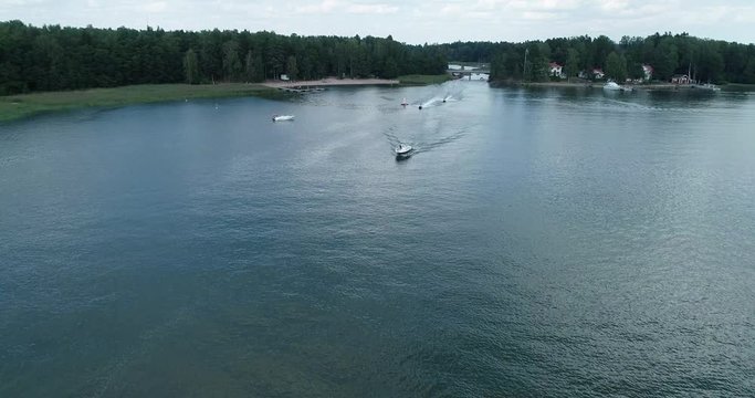 Aerial footage top view with motor boats and jetskies at high speed cuts the waves while is leaving a long white trail. Conceptual video presentation for tourism. Expensive lifestyle and kind of leisu