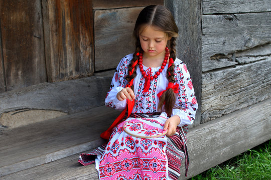 Girl Embroidery Rushnik.Hands of girl woman female in ukrainian traditional shirt sewing embroidery pattern in embroidery frame.
