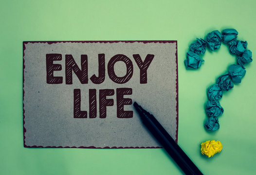Word writing text Enjoy Life. Business concept for Any thing, place,food or person, that makes you relax and happy Gray paper marker crumpled papers forming question mark green background