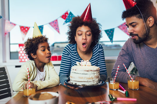 Happy family celebrating a birthday together at home