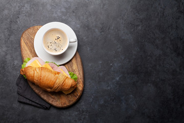 Coffee and croissant sandwich