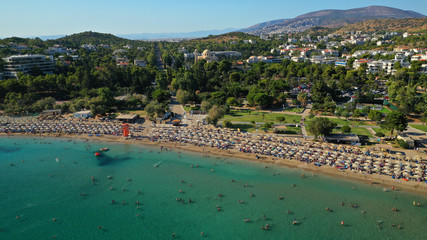 Fototapeta na wymiar Aerial drone photo of famous paradise celebrity sandy beach of Astir or Asteras in south Athens riviera with turquoise clear waters, Vouliagmeni, Greece