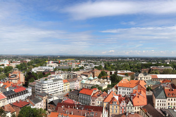 Fototapeta na wymiar Wonderful view from historical tower in Hradec Kralove. Market square and historical part of town. Ancient houses alternating with trees. Ecological city in czech republic